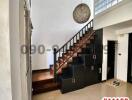 Spacious entrance hallway with elegant staircase and unique pendant lights