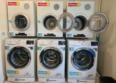 Various washing machines on display in a store