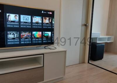 Modern living room with large TV and air conditioning unit