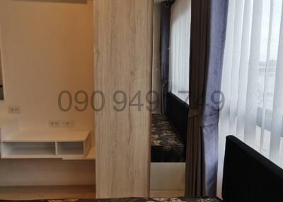 Compact modern bedroom with air conditioning unit and ample natural light