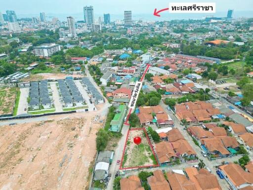 Aerial view of a residential area showing both a developed housing estate and surrounding community