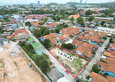 Aerial view of a residential plot for sale outlined in red
