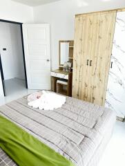 Modern styled bedroom with a comfortable bed and wooden wardrobe