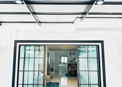 View into a modern home interior through large glass doors