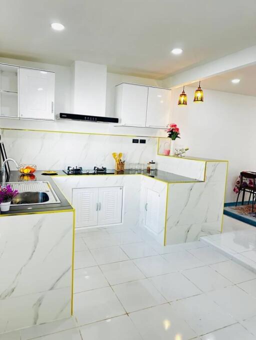 Modern Kitchen with Marble Countertops and Pendant Lighting