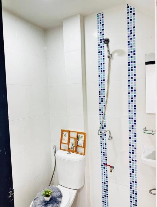 Compact bathroom with white tiles and shower