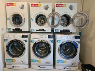 A variety of washing machines on display in an appliance store