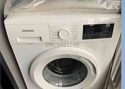 Siemens front-loading washing machine in a home laundry area