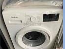 Siemens front-loading washing machine in a home laundry area