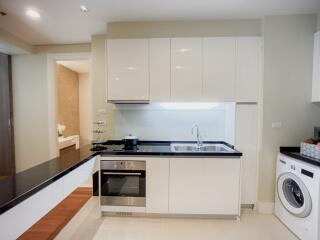 Modern kitchen with built-in appliances and neutral color scheme