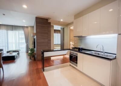 Modern kitchen with open concept leading to the living area in a bright apartment