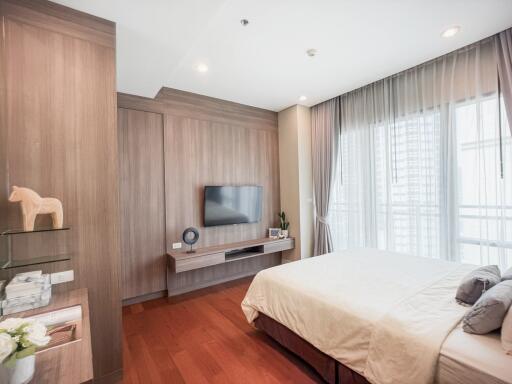 Modern bedroom interior with wooden finish and natural light