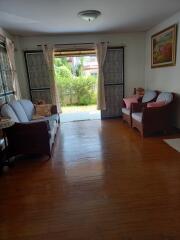 Spacious living room with natural lighting and hardwood floors