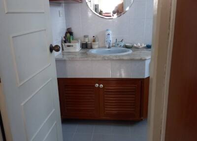 Compact bathroom with vanity mirror and under-sink storage