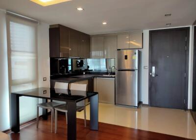 Modern kitchen with stainless steel appliances and ample lighting