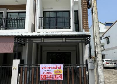 Modern two-story house facade with a for sale sign