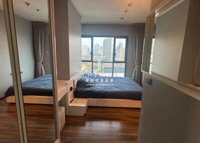 Spacious bedroom with large window and city view