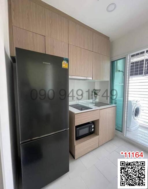 Modern kitchen with stainless steel appliances and wooden cabinets