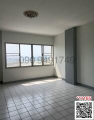 Empty bedroom with tiled floor and large windows