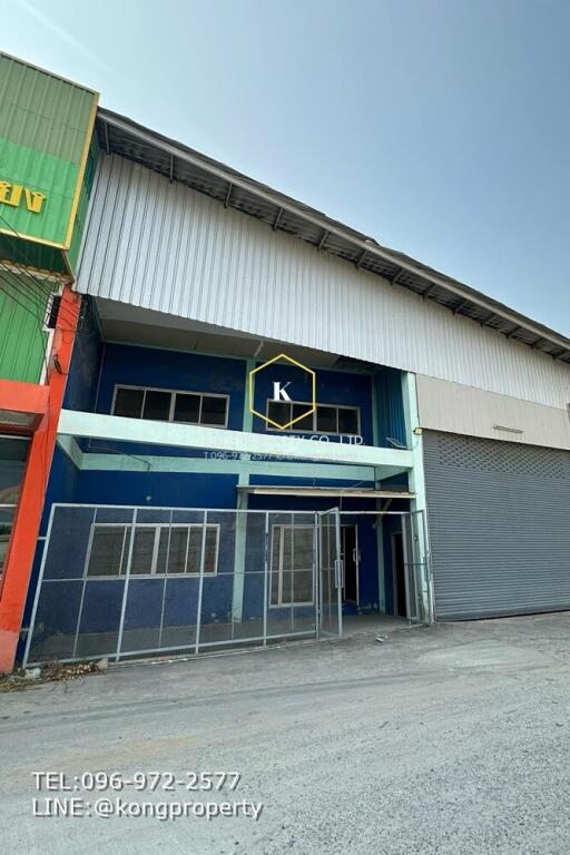 Exterior of a commercial warehouse building with company signage