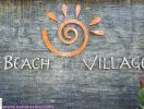 Beach Village sign on a textured backdrop