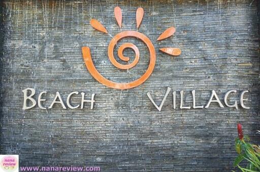 Beach Village sign on a textured backdrop