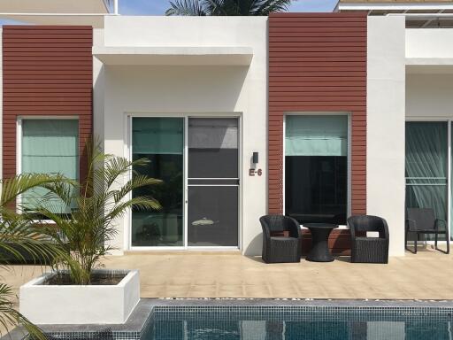 Modern house exterior with a pool and outdoor seating area