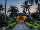 Tropical villa exterior at twilight with palm trees and pathway