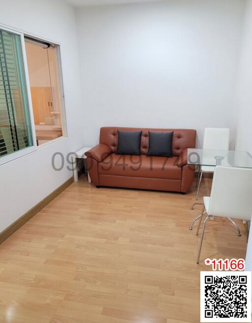 Modern living room with leather sofa and dining area