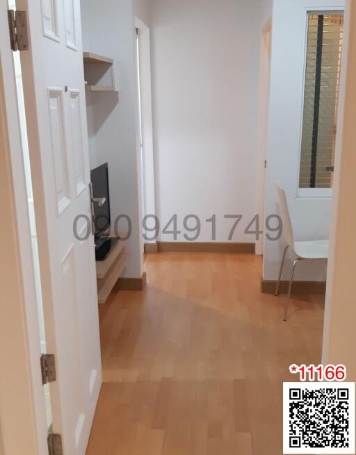 Bright corridor with wooden flooring