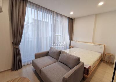 Spacious bedroom with a large bed and a comfortable sofa