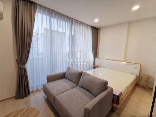 Spacious bedroom with a large bed and a comfortable sofa