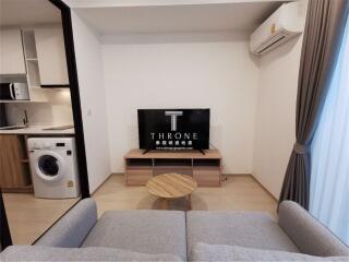 Modern living room with integrated appliances and cozy furnishings