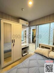 Cozy bedroom with a large bed, mirrored wardrobe, and an attached bathroom