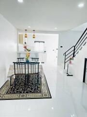 Bright and modern dining area with staircase