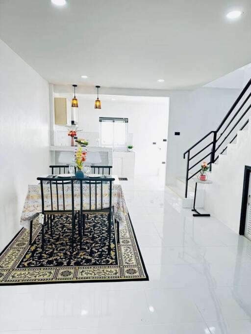 Bright and modern dining area with staircase