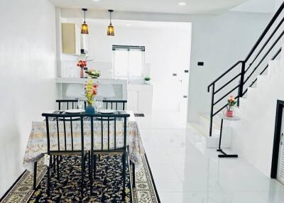 Bright and modern dining area with staircase