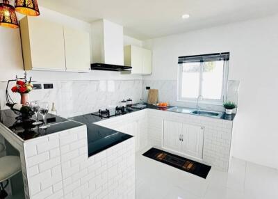 Modern kitchen with white cabinetry and natural light