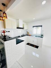 Modern kitchen with white cabinetry and natural light