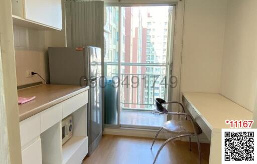 Compact kitchen with modern appliances and balcony access