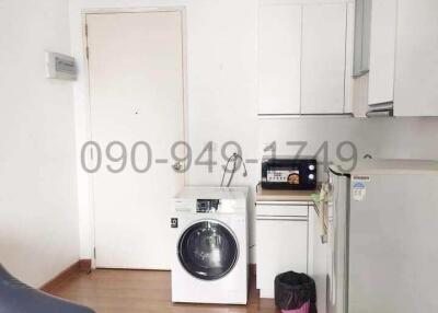 Compact kitchen with white appliances and wooden flooring