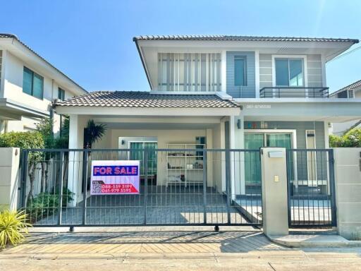 Modern two-story house with balcony and gated entrance for sale