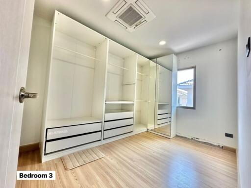 Spacious bedroom with mirrored closet and built-in shelving