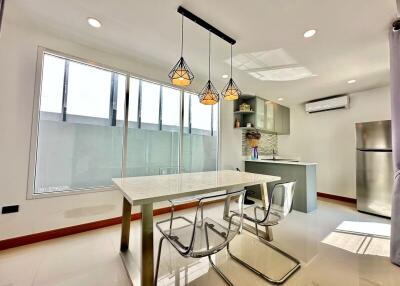 Modern kitchen with sleek design, natural lighting, and integrated appliances