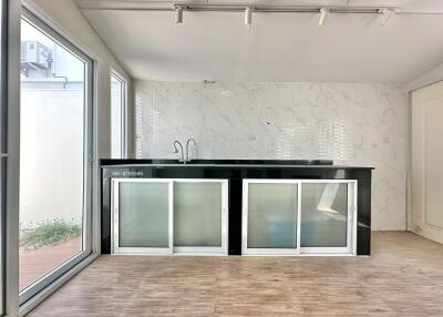 Modern kitchen with large windows and marble countertops