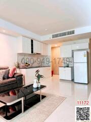 Spacious living room with modern furniture and an open kitchenette