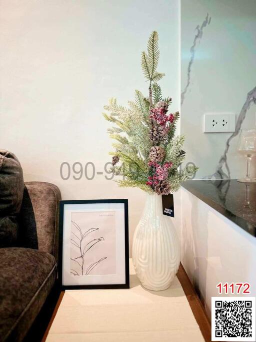 Elegant corner of a living room with decorative vase and framed artwork