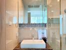 Modern bathroom with a glass shower and marble vanity