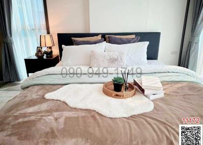 Cozy and well-decorated bedroom with stylish bedding and ambient lighting