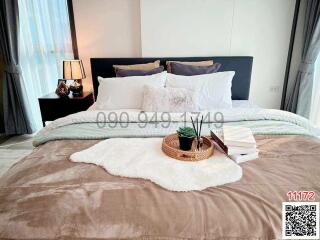 Cozy and well-decorated bedroom with stylish bedding and ambient lighting